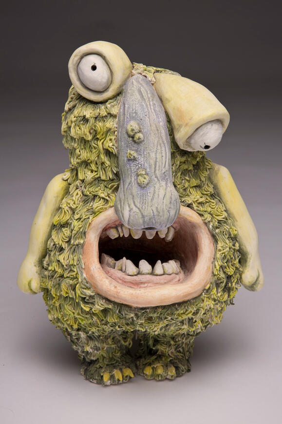 Sarah Alonzo Artist - Ceramics Ceramic green monster with mouth open and a large nose.